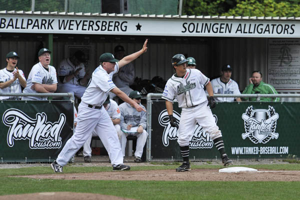 Andy Fleischacker coaching at third base for the Alligators